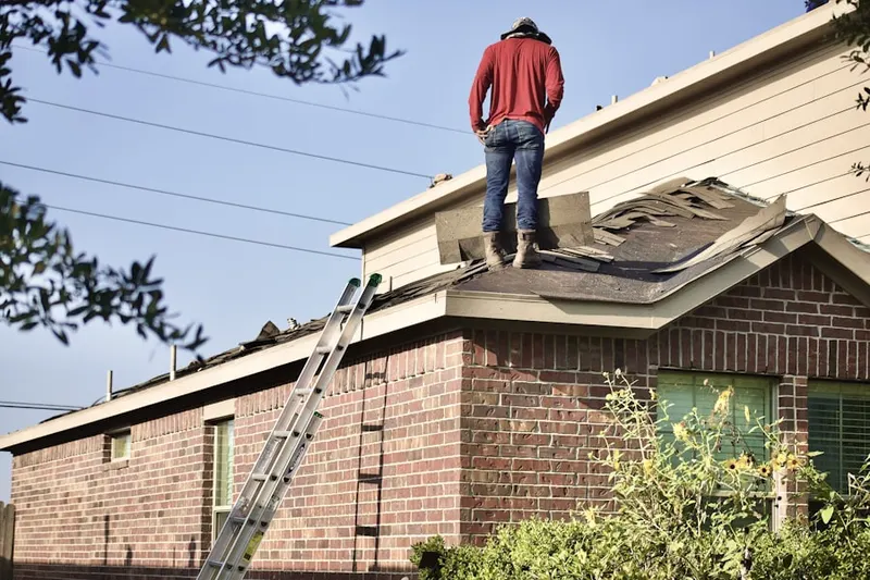 Professional roofer working on a residential roof in Countryside Woods